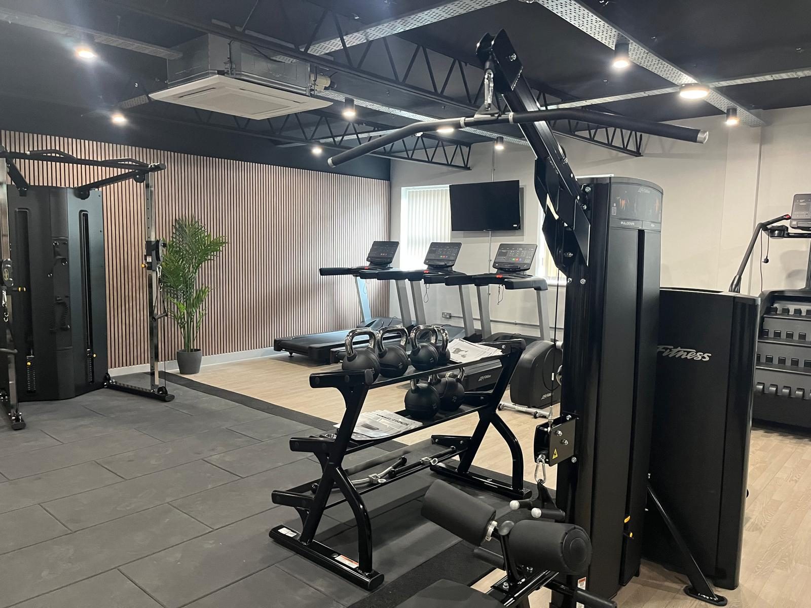 Clean and well-maintained commercial gym facility following professional cleaning and hygiene services
